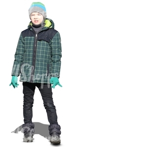 young boy in a green winter jacket standing in the sunlight