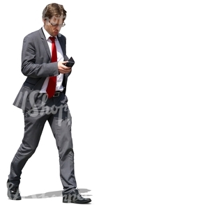 businessman walking and looking at his phone