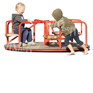 two boys playing on a carousel
