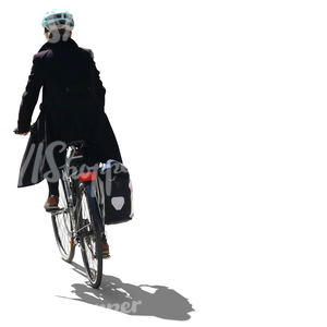 backlit woman with a helmet riding a bike