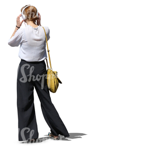 woman with headphones standing and listening to music