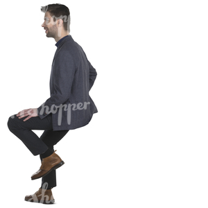 man in a suit sitting on a bar stool