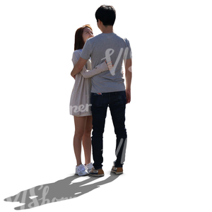 backlit young asian couple standing and looking at each other
