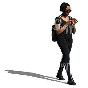 afrcian woman walking and looking at her phone