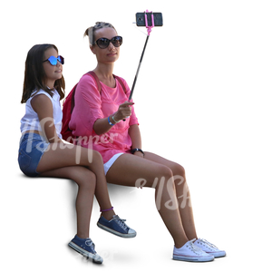 mother and daughter sitting and taking a selfie together