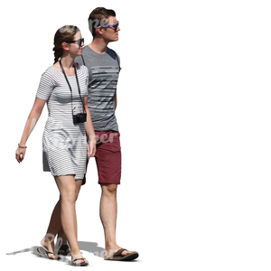 young man and woman walking hand in hand in summer