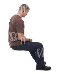 man sitting in a room and looking at his phone