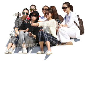 group of asian women sitting on the stairs and taking a selfie