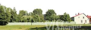 suburbian landscape with a house and a fence