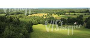 aerial view of a landscape of meadows and trees