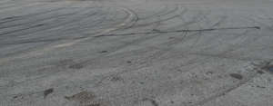 tarmac field with tyre tracks