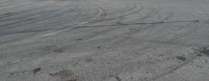 tarmac field with tyre tracks