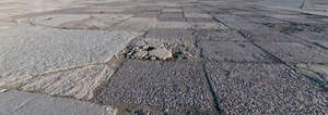 worn out tarmac plates in sunlight