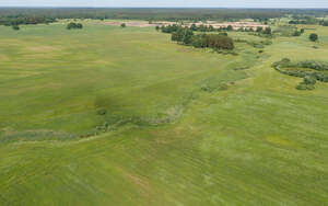 bird-eye view of a ground with river abd fields