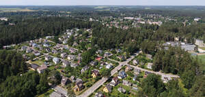 small suburb with trees and roads seen from above