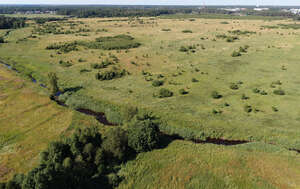 aerial view of a river running through grasslands