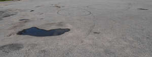 tarmac field with some puddles