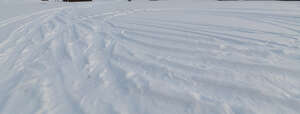 field of snow with tyre tracks