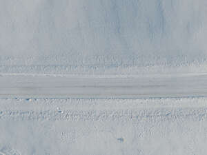 aerial view of a snow covered road