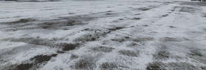 icy asphalt field with tyre tracks