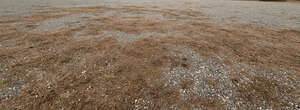 field of gravel and dry grass