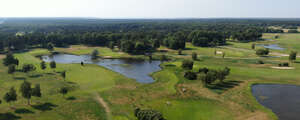 aerial view of a golf course with ponds