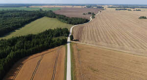 aerial view of a countryside with fieldsd and a road