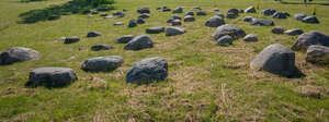 grass field with rubble stones
