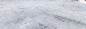 paved field with thin layer of snow
