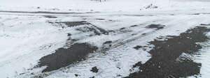 snowy tarmac with tyre tracks