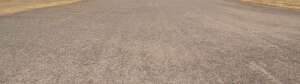 light brown asphalt and gravel road