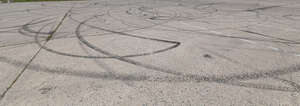 light grey concrete ground with tyre tracks