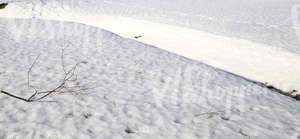 snow-covered ground with a ditch