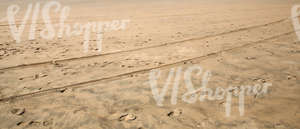 sandy beach with tracks and footprints