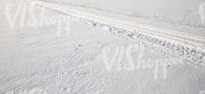 snow-covered ground with snowmobile tracks