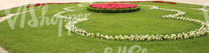 park ground with pink and white formal flowerbeds