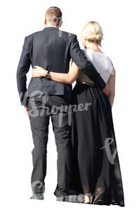 couple in formal clothes standing together on a balcony