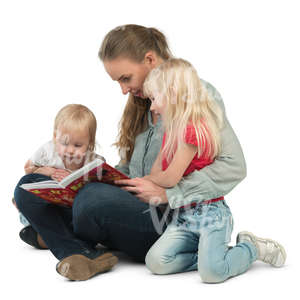 woman with her two daughters sitting on the floor and reading a book