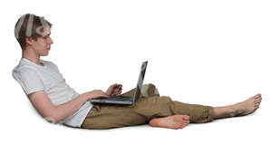 young man sitting on a couch and working with his laptop