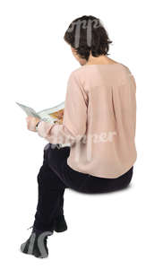 woman sitting and reading a newspaper