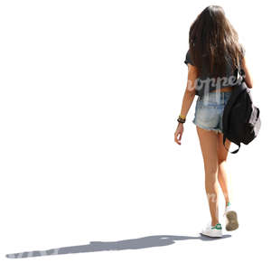 backlit young woman with long hair walking down the street