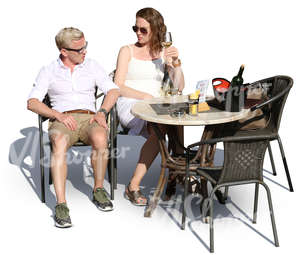 man and woman sitting in a cafe and drinking wine