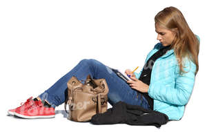 woman sitting on the ground and writing in her notebook