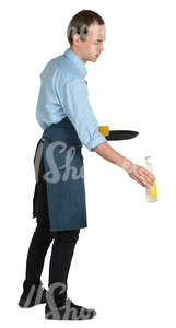 young waiter putting drinks on the table