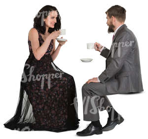 man and woman in fancy clothes sitting in a cafe