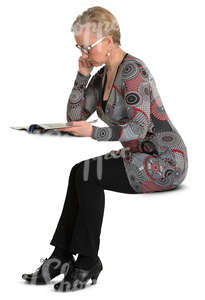 woman sitting at the table and reading a newspaper