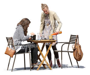 two women hanging in a cafe and eating and drinking