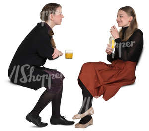 two girls sitting in a cafe and talking