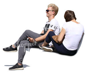 young man and woman sitting on a bench and laughing