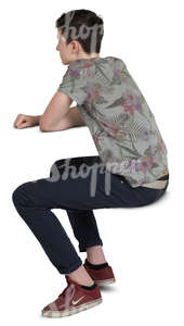 teenage boy sitting behind a table